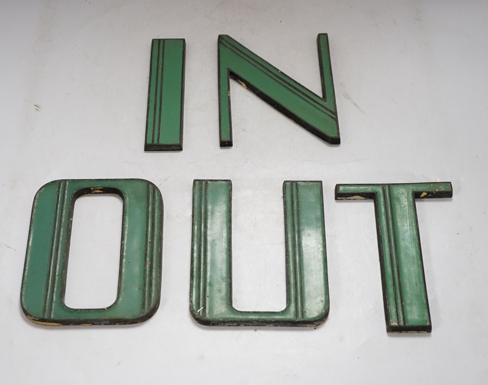 Art Deco green enamelled cast metal letters to spell ‘IN’ and ‘OUT’, 15cm tall. Condition - fair to good